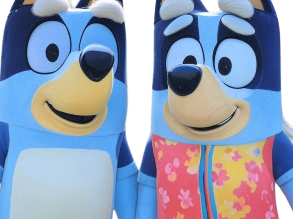 Two costumed characters dressed as the Bluey Grannies PNG, wearing a floral jacket and smiling on a transparent background.